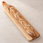 Maple baguette board shown from end to end with a loaf of bread