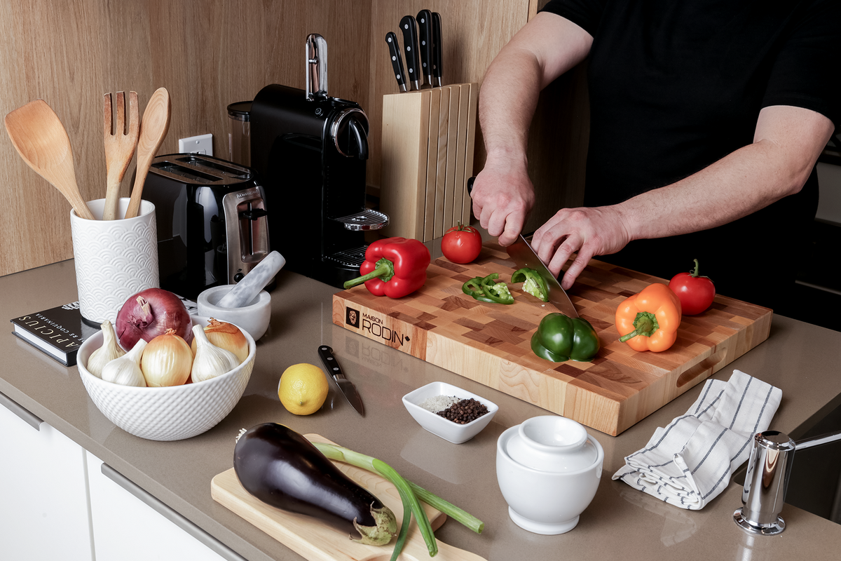 Maple and birch end-grain butcher block, 18 × 16 in on a kitchen counter with vegetables and a chef’s knife