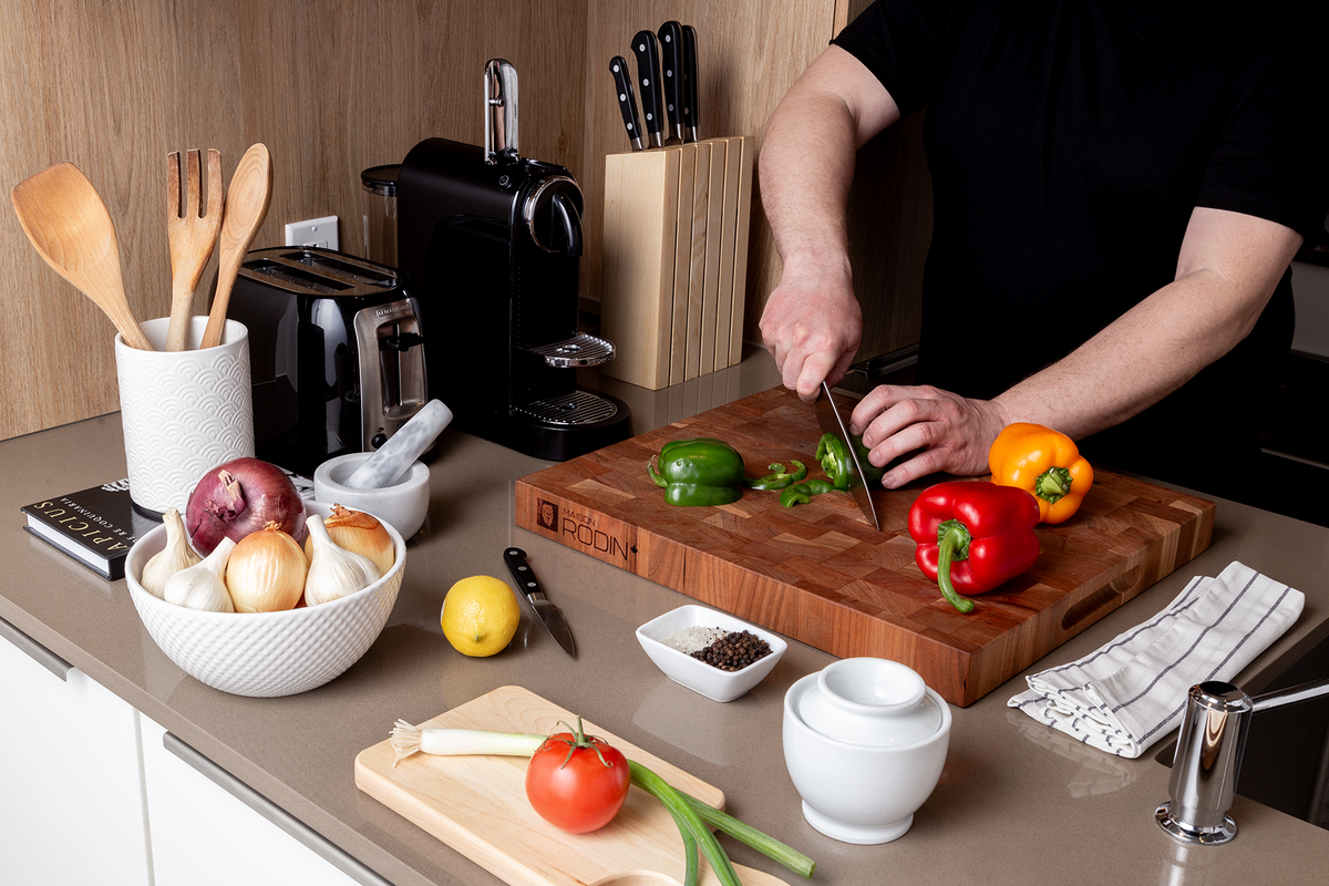 Cherry end-grain butcher block, 18 × 16 in on a kitchen counter with vegetables and a chef’s knife