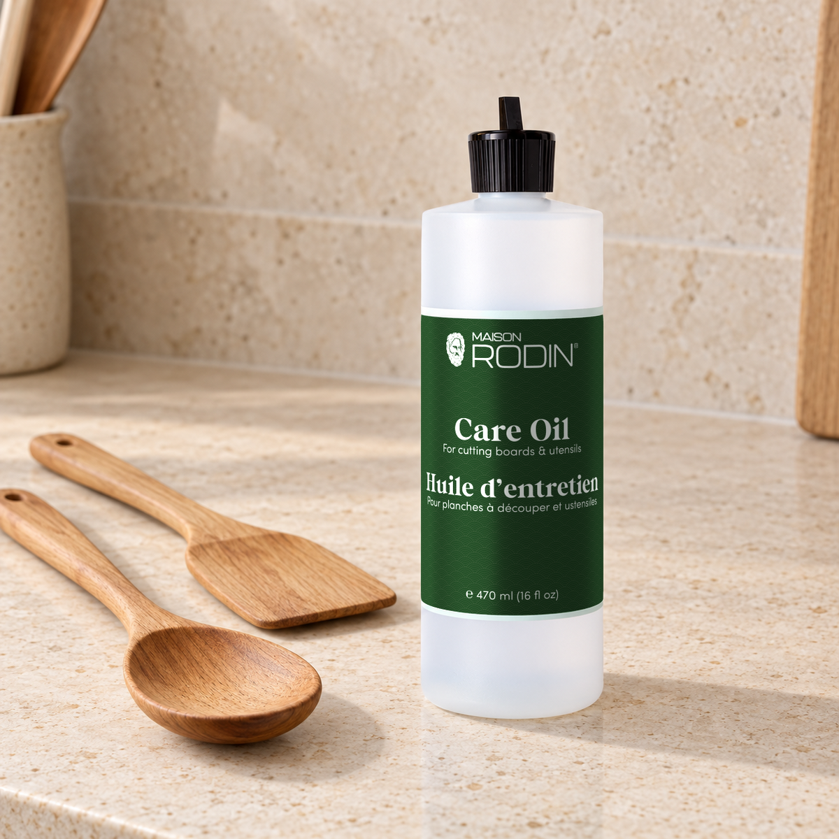 MAISON RODIN Care Oil beside a wooden spoon and spatula on a kitchen counter