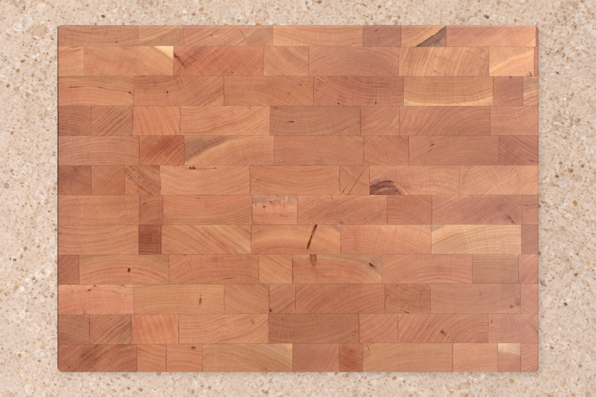 An illustrated cherry-wood board before oiling, with a lighter matte tone
