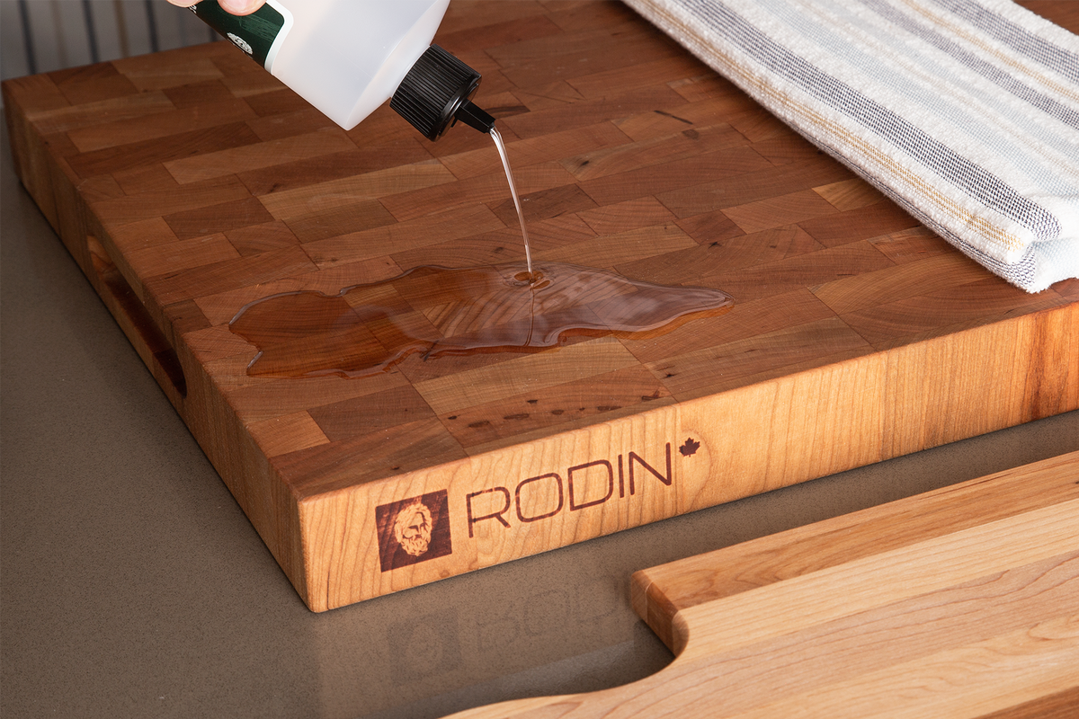 MAISON RODIN Care Oil bottle beside a maple butcher block and kitchen towel