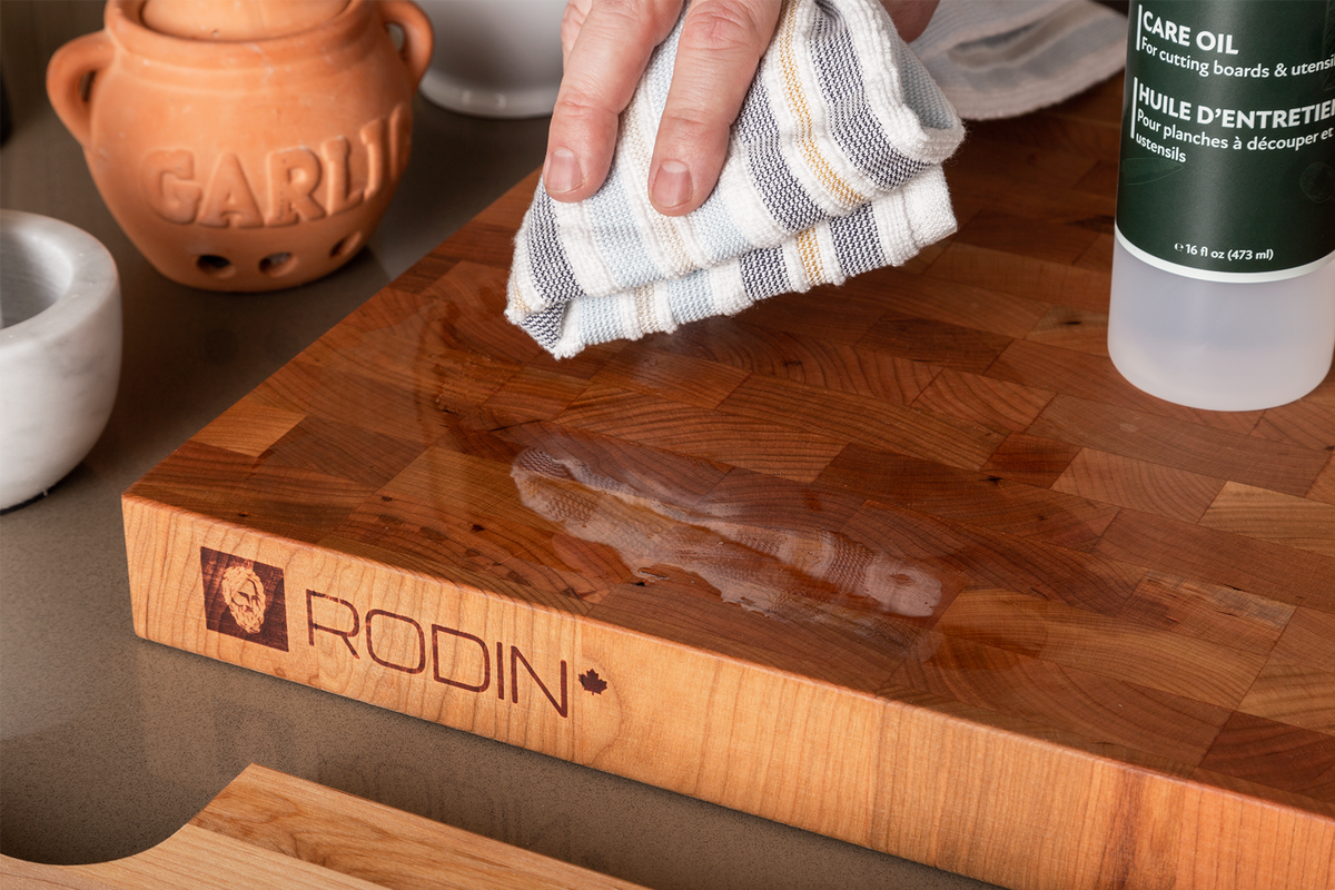 MAISON RODIN Care Oil bottle beside a maple butcher block and kitchen towel