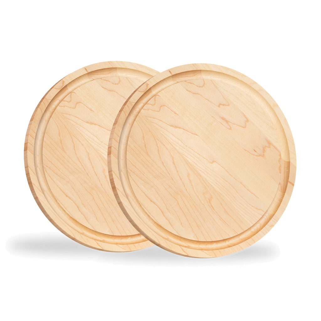 Two round maple steak boards standing upright, viewed at an angle