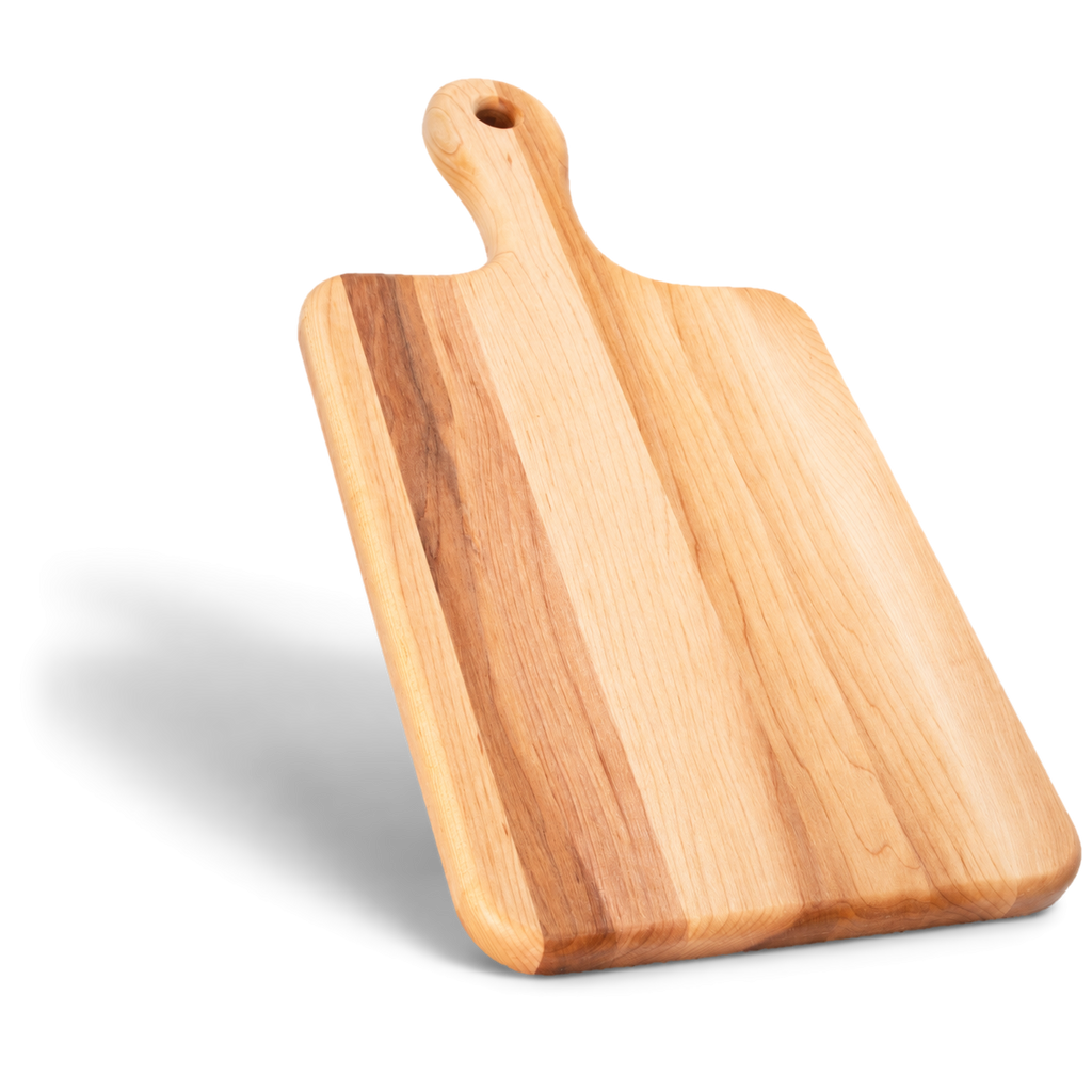 Large maple serving board standing on its short end, with the handle pointing up