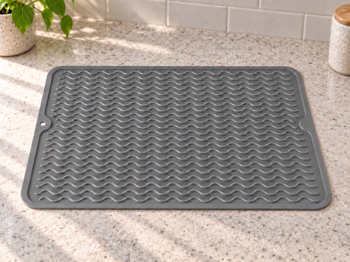 Grey silicone mat laid flat, with wavy ridges, rounded corners and a hanging hole