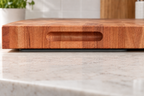 Silicone mat beneath a larger cherry butcher block, with the block extending beyond its edges. Block sold separately.