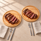 Two round maple steak boards arranged as individual place settings